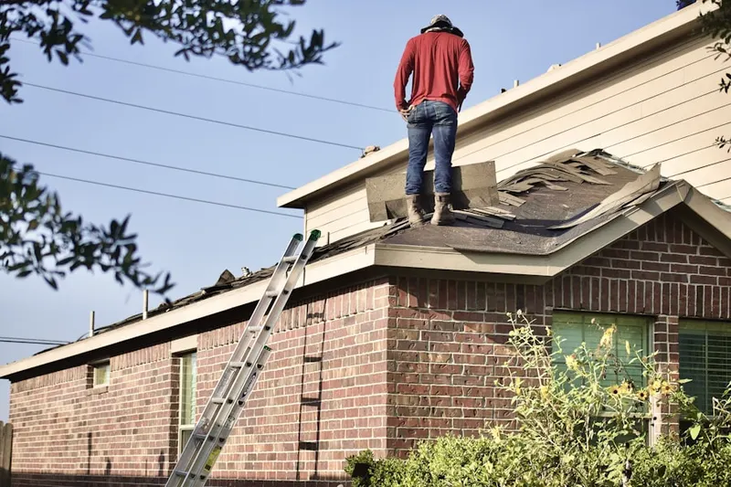 Professional roofer working on a residential roof in Oakbrook Station